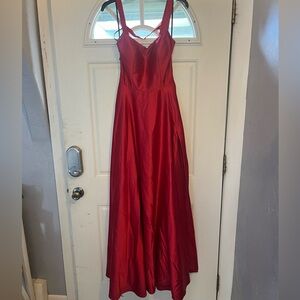 Full length red satin prom dress. Mostly open back. Size 9. Pockets. Used once.